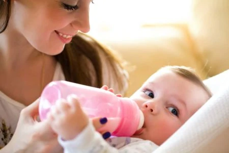 Mother bottle feeding her baby
