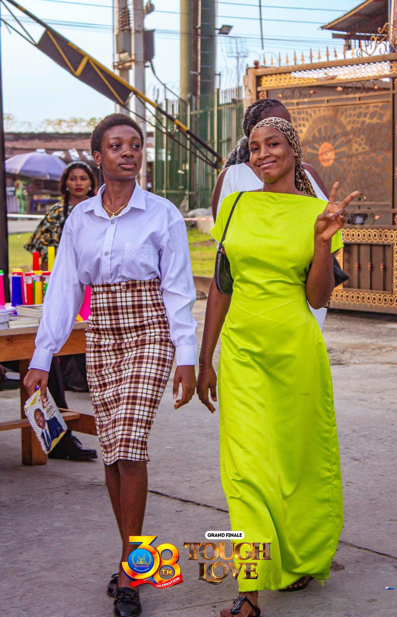 Two members smiling as they arrive at the church gate for a service