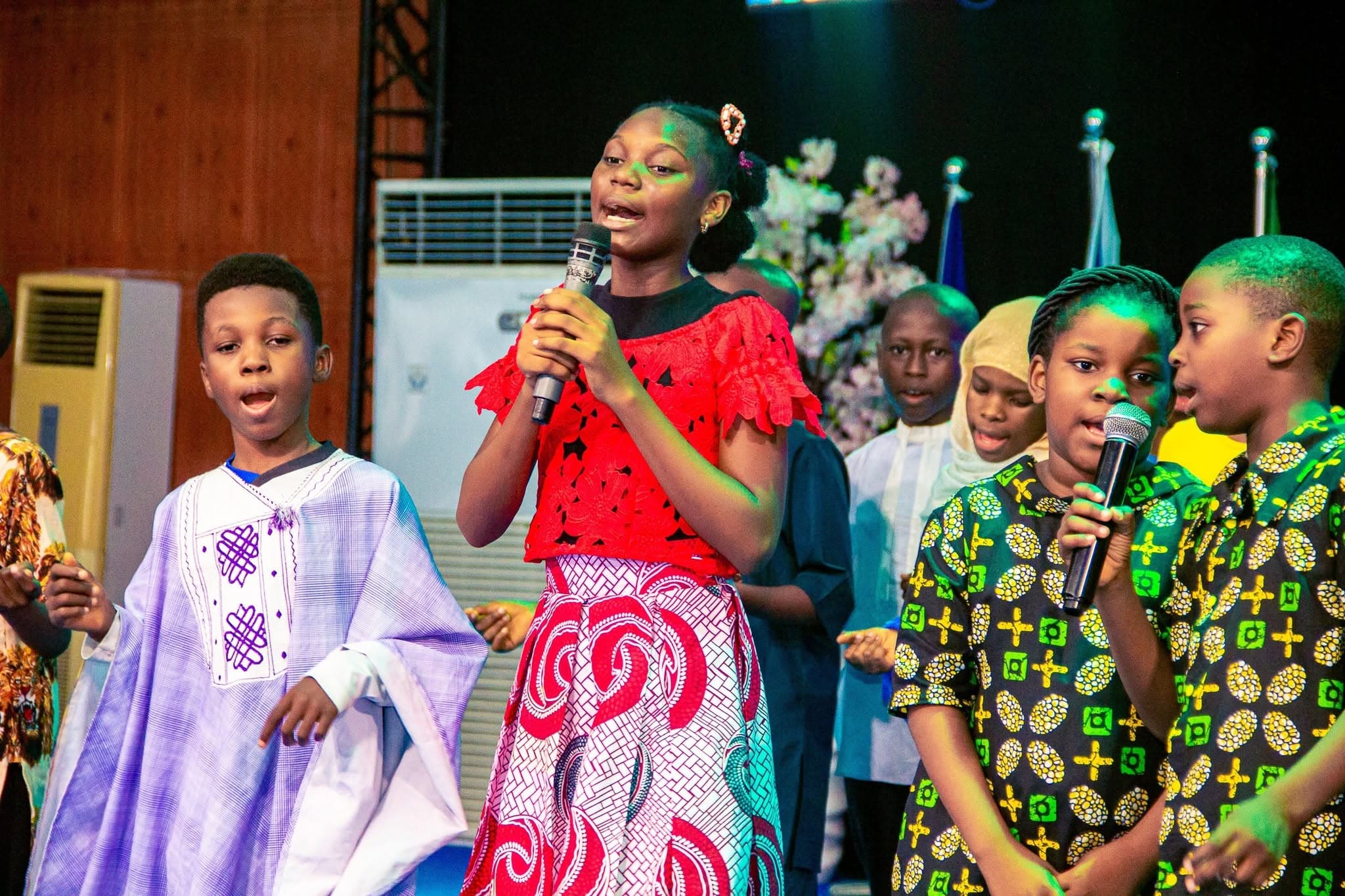 Children singing into microphones during children's church