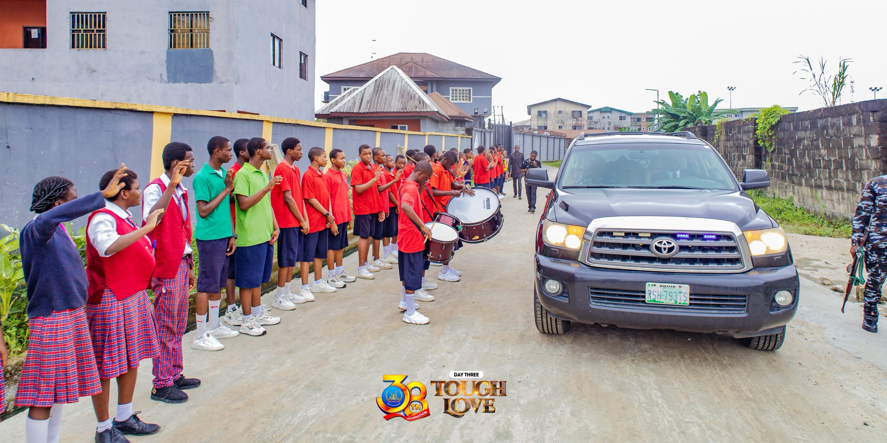 The school band lined up outside to welcome arriving guests at a church event