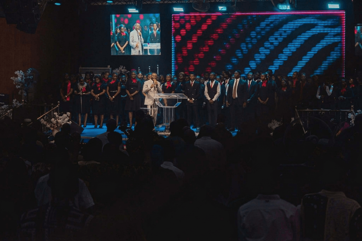 A Salem City of Faith service, with the minister preaching on stage and the choir behind him